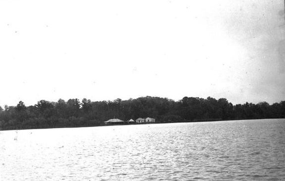 This is probably Kitty Hawk, Roy Hampton’s fishery on the north side of the Roanoke, as seen from the Slade fishery on the other side of the river. The buildings included a packing and salting house, an engine shed, a mess hall and kitchen, and barracks for the fishermen and women. Photo courtesy, State Archives of North Carolina