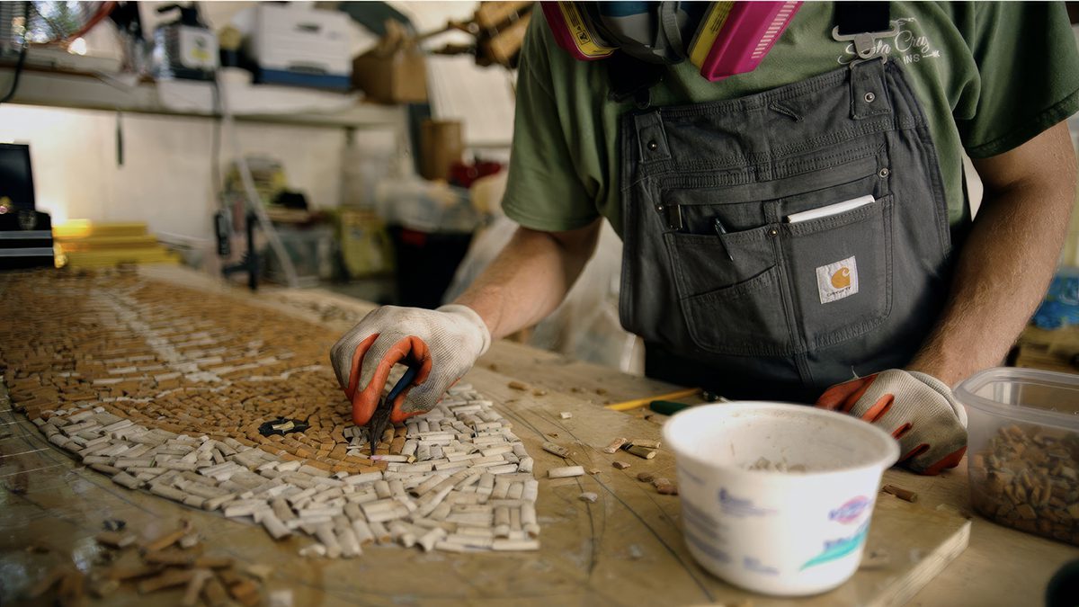 Surfboard shaperTaylor Lane builds a cigarette butt surfboard as environmental advocacy, the subject of the documentary film, "The Cigarette Surfboard." Photo provided.