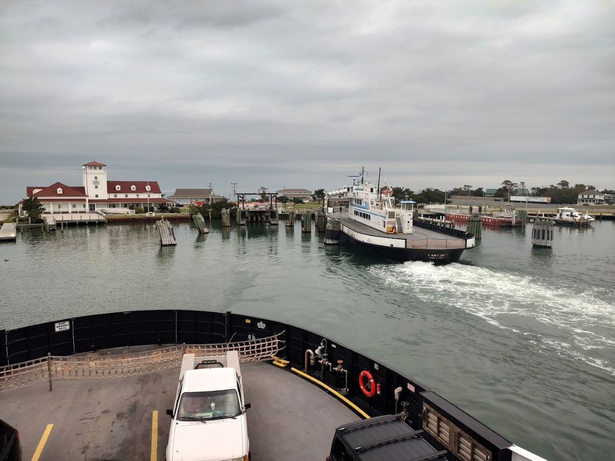 Clouds fill the sky as a ferry departs from the Ocracoke terminal on Silver Lake in 2023. Photo: Jennifer Allen