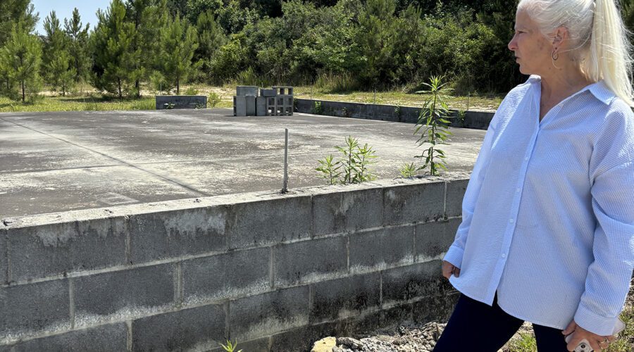 Paws Place President Lee VanOrmer explains recently how the Winnabow dog rescue had just enough money to pay a contractor to pour an elevated concrete slab that will be the base of the storm shelter for animals that must be evacuated to higher ground. Photo: Trista Talton