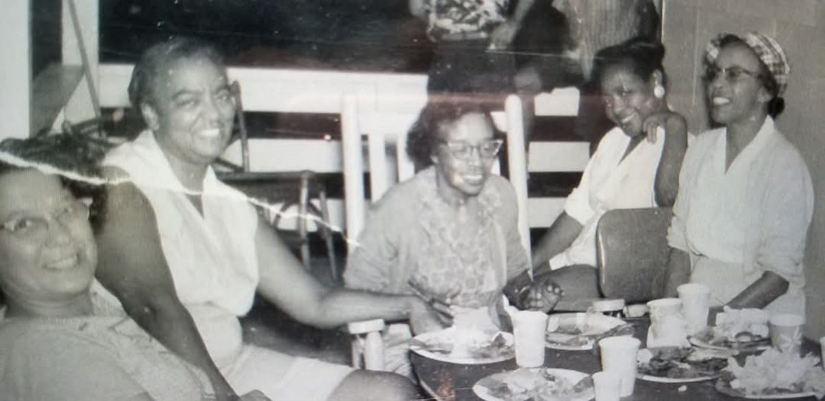 Women chat after a meal. Photo: Contributed