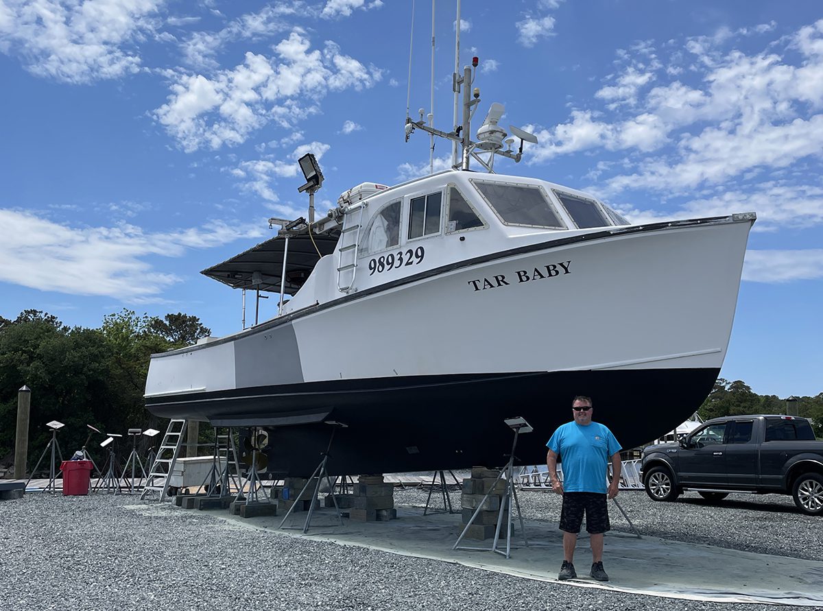 Hemilright poses next to his longline fishing vessel. Photo: Kip Tabb