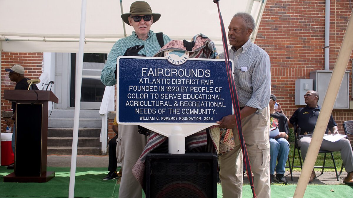 Chowan Discovery Group Executive Director Marvin Jones, left, and Atlantic District Fair Association Chairman James Peele unveil the marker, yet to be erected, June 14 at the R.L. Vann School at 415 Holloman Ave. in Ahoskie. Photo: Kip Tabb