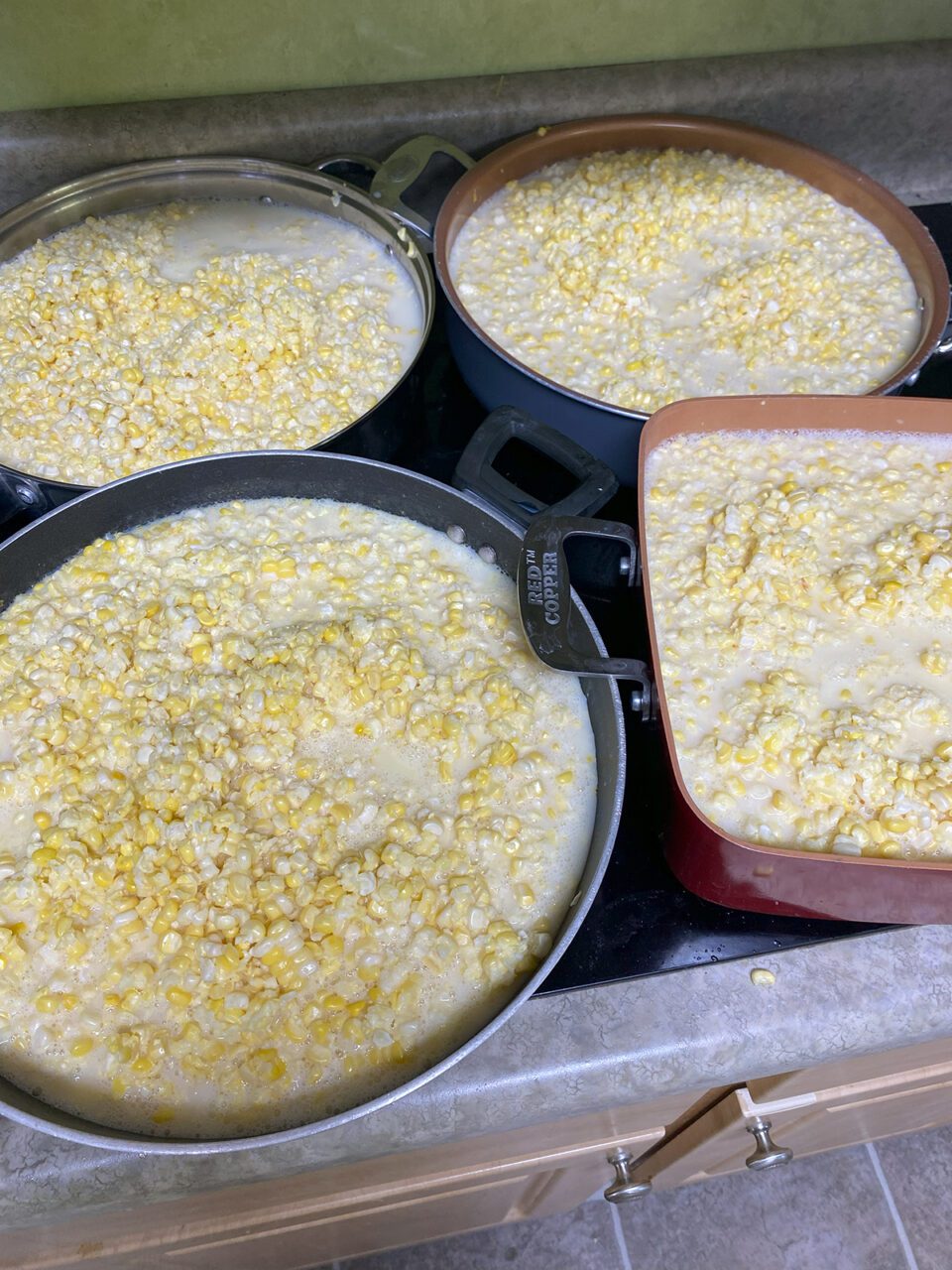 Sweet corn cut off the cob simmers on the stovetop in preparation for freezing. Photo: Heidi Skinner