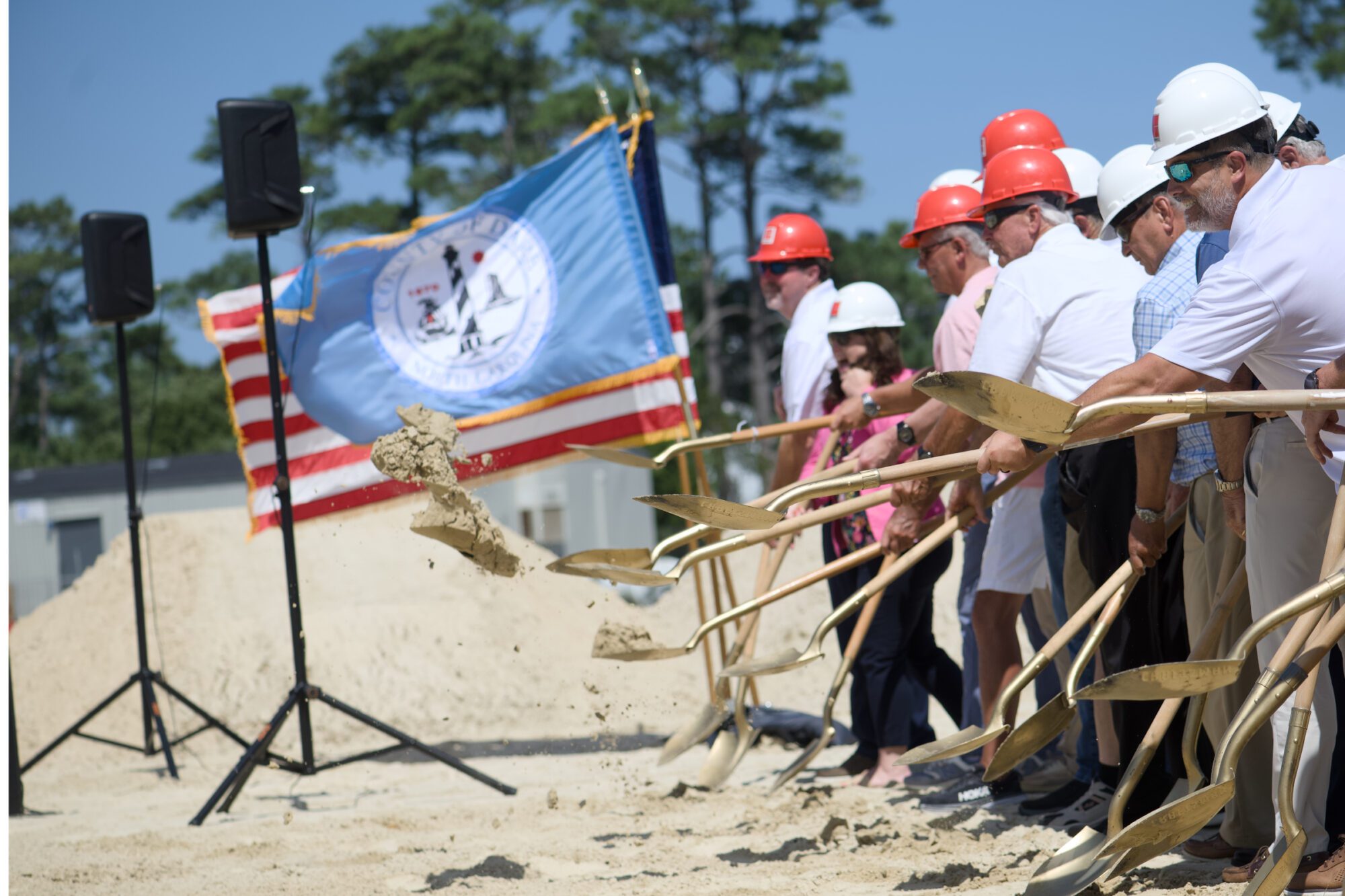 Dirt flies as Dare County elected officials break ground for the early college building on the College of the Albemarle Manteo campus. Photo: Kip Tabb
