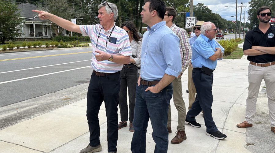 Pollocksville Mayor Jay Bender points out for state Attorney General Jeff Jackson Tuesday various structures in town set to be elevated using the federal funding. Photo: Trista Talton