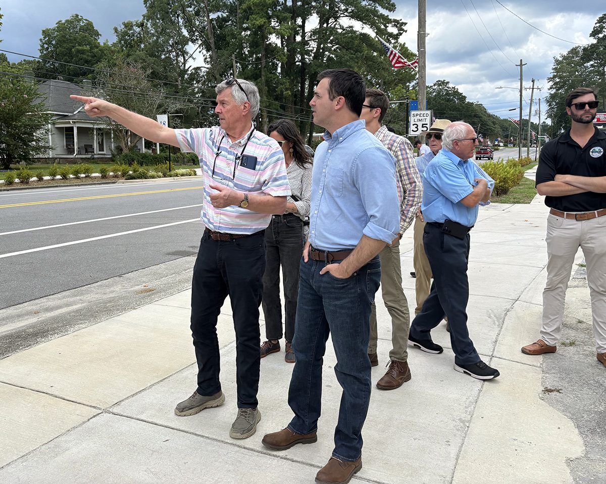 Pollocksville Mayor Jay Bender points out for state Attorney General Jeff Jackson Tuesday various structures in town set to be elevated using the federal funding. Photo: Trista Talton