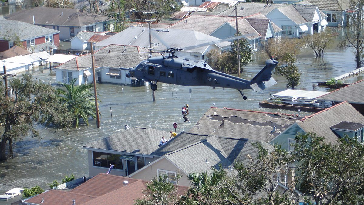 A crew from the 103rd Rescue Squadron, based on F.S. Gabreski Air National Guard Base in Westhampton Beach, New York, lift a person to safety from the roof of a flooded home in New Orleans on Sept. 6, 2005, after Hurricane Katrina. Photo: Col. Andrew Wineberger, U.S. Air National Guard