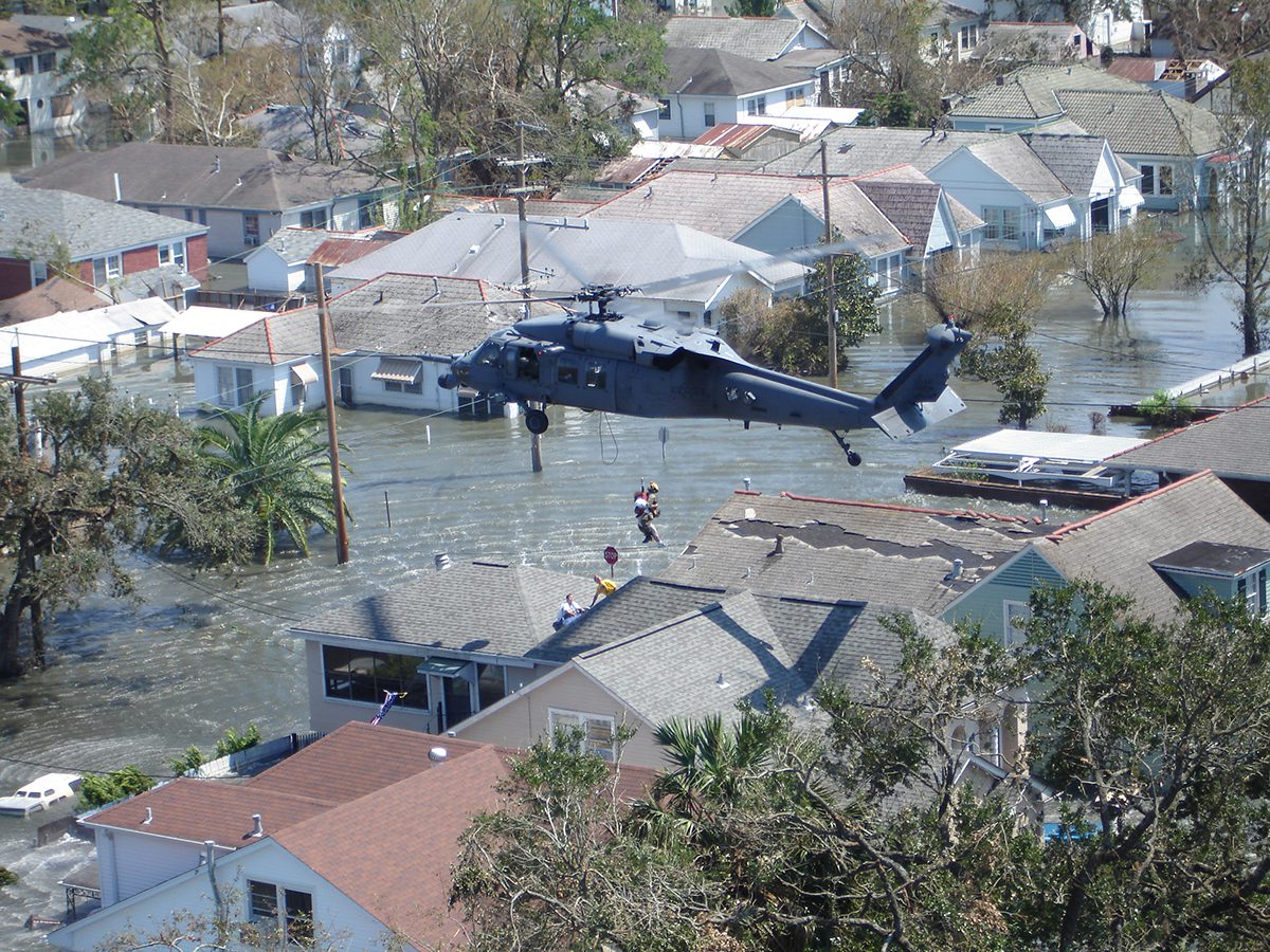 A crew from the 103rd Rescue Squadron, based on F.S. Gabreski Air National Guard Base in Westhampton Beach, New York, lift a person to safety from the roof of a flooded home in New Orleans on Sept. 6, 2005, after Hurricane Katrina. Photo: Col. Andrew Wineberger, U.S. Air National Guard