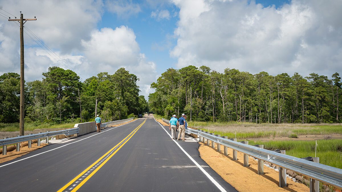 A group inspects completed repairs to the bridge over Prices Creek on East Moore Street in Southport, which was damaged during an unnamed cyclone that brough historic rainfall and flooding on Sept. 16, 2024. Photo: NCDOT