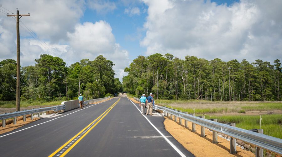 A group inspects completed repairs to the bridge over Prices Creek on East Moore Street in Southport, which was damaged during an unnamed cyclone that brough historic rainfall and flooding on Sept. 16, 2024. Photo: NCDOT