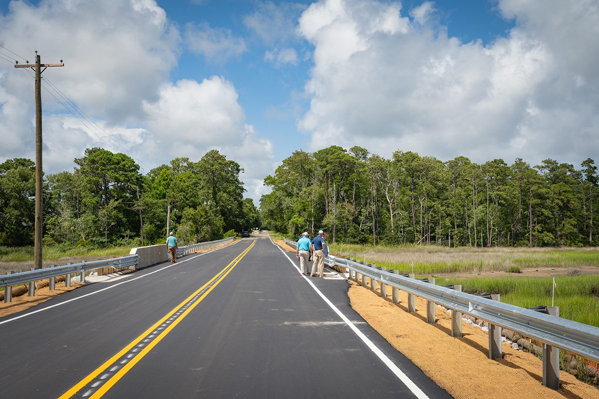 A group inspects completed repairs to the bridge over Prices Creek on East Moore Street in Southport, which was damaged during an unnamed cyclone that brough historic rainfall and flooding on Sept. 16, 2024. Photo: NCDOT
