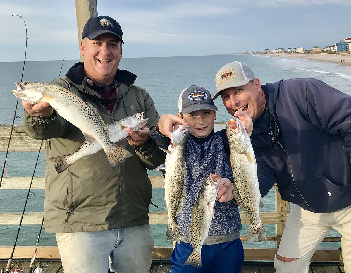 Gordon Churchill, left, shares a memorable fishing experience with Emerson Ellis and his dad Chris Ellis of Sneads Ferry.