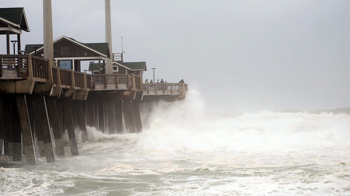 People on Jennette's Pier in Nags Head watch as waves generated by Hurricane Erin crash into the concrete structure that's part of the North Carolina Aquariums system. The storm's center was about 260 miles east of Cape Hatteras about midday Thursday and moving out to sea, but hurricane-force winds extended outward up to 105 miles and tropical-storm-force winds extended up to 320 miles the sprawling storm's eye. Life-threatening surf and rip current conditions will likely continue as storm surge and flood risks subside. The pier's website provides information on current conditions and live webcam views. Photo: Kip Tabb