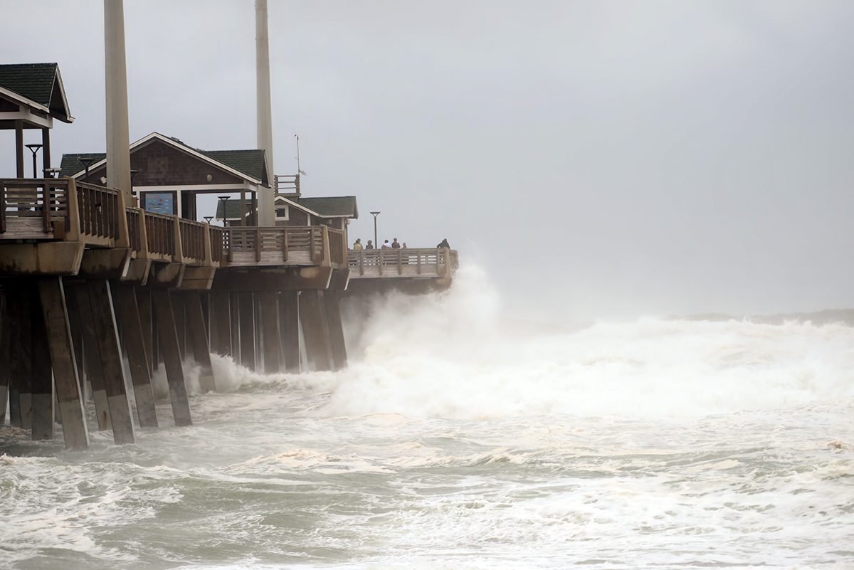 People on Jennette's Pier in Nags Head watch as waves generated by Hurricane Erin crash into the concrete structure that's part of the North Carolina Aquariums system. The storm's center was about 260 miles east of Cape Hatteras about midday Thursday and moving out to sea, but hurricane-force winds extended outward up to 105 miles and tropical-storm-force winds extended up to 320 miles the sprawling storm's eye. Life-threatening surf and rip current conditions will likely continue as storm surge and flood risks subside. The pier's website provides information on current conditions and live webcam views. Photo: Kip Tabb