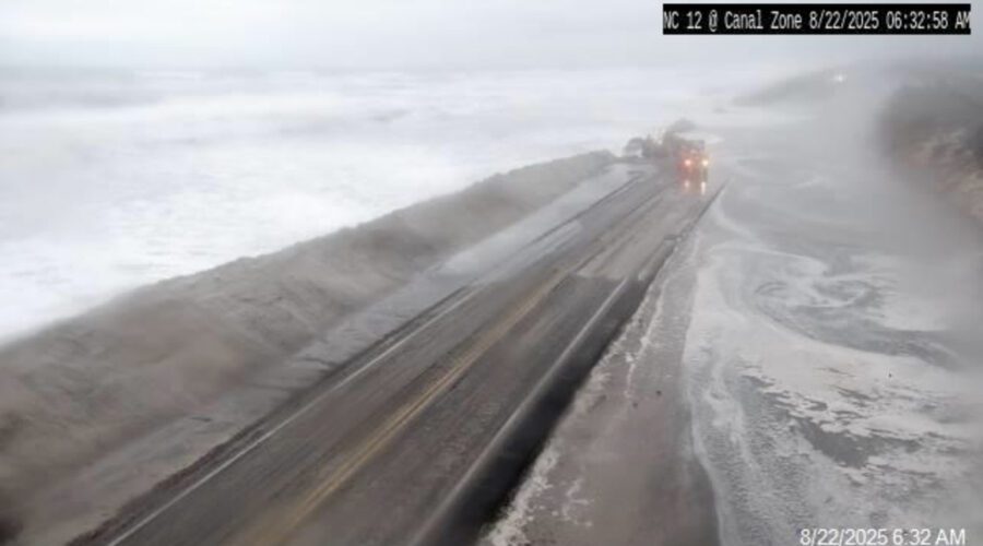 Oceanwater floods N.C. Highway 12 Friday morning at the Canal Zone just south of Oregon Inlet, one of two dune breaches opened by Hurricane Erin. Photo: NCDOT