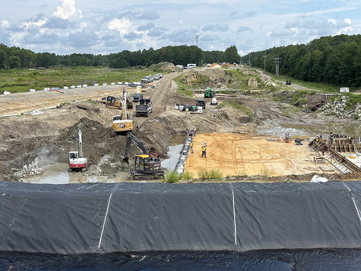 Crews work on reconstructing Boiling Spring Lakes' Sanford Dam, the city's largest dam, July 30. Photo: Trista Talton