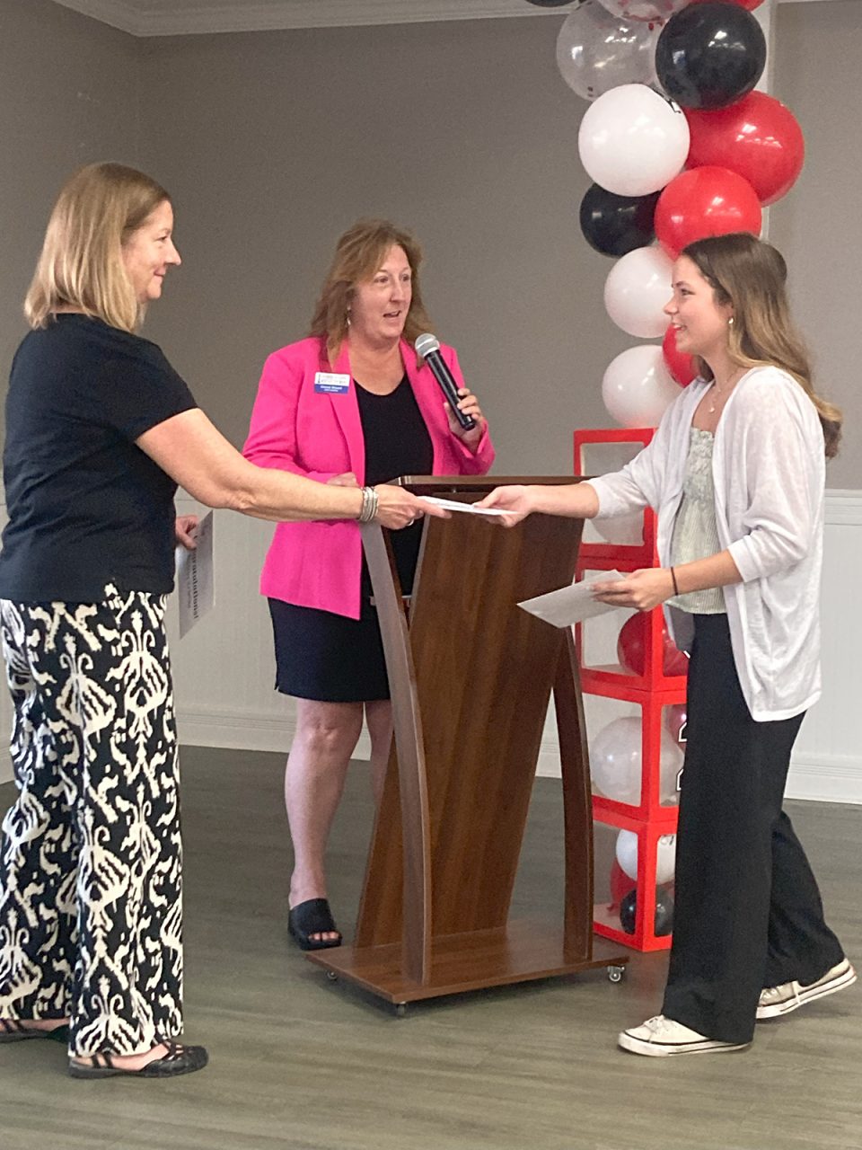 From left, Outer Banks Association of Realtors member Shelley O’Grady and 2025 President Christi Bryant present an award to Cape Hatteras Secondary School student Kristin Bennett. Photo: Outer Banks Association of Realtors