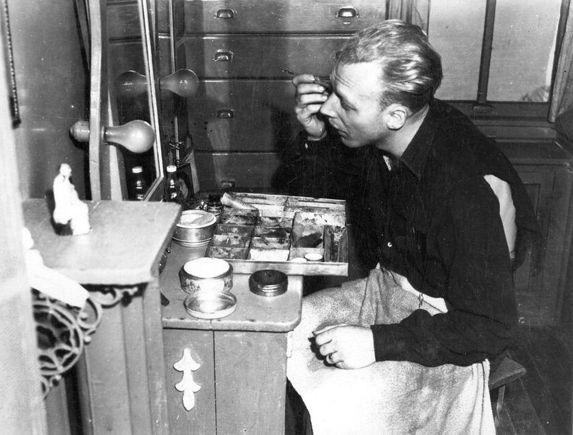 stage manager and actor Daile Herlit applies makeup before a performance. Photo courtesy, State Archives of North Carolina