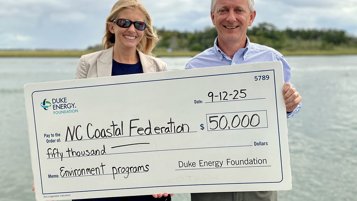 Duke Energy Foundation District Manager, Government and Community Relations, Lauren Wargo presents a ceremonial $50,000 check to North Carolina Coastal Federation Executive Director Braxton Davis earlier this month in Morehead City.