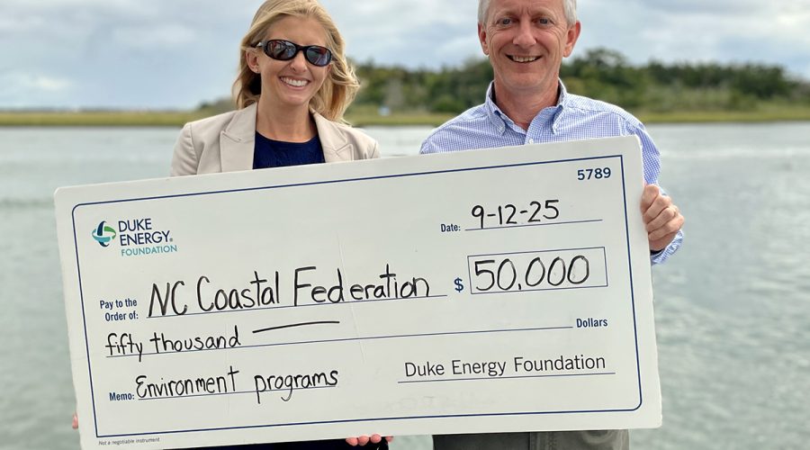 Duke Energy Foundation District Manager, Government and Community Relations, Lauren Wargo presents a ceremonial $50,000 check to North Carolina Coastal Federation Executive Director Braxton Davis earlier this month in Morehead City.