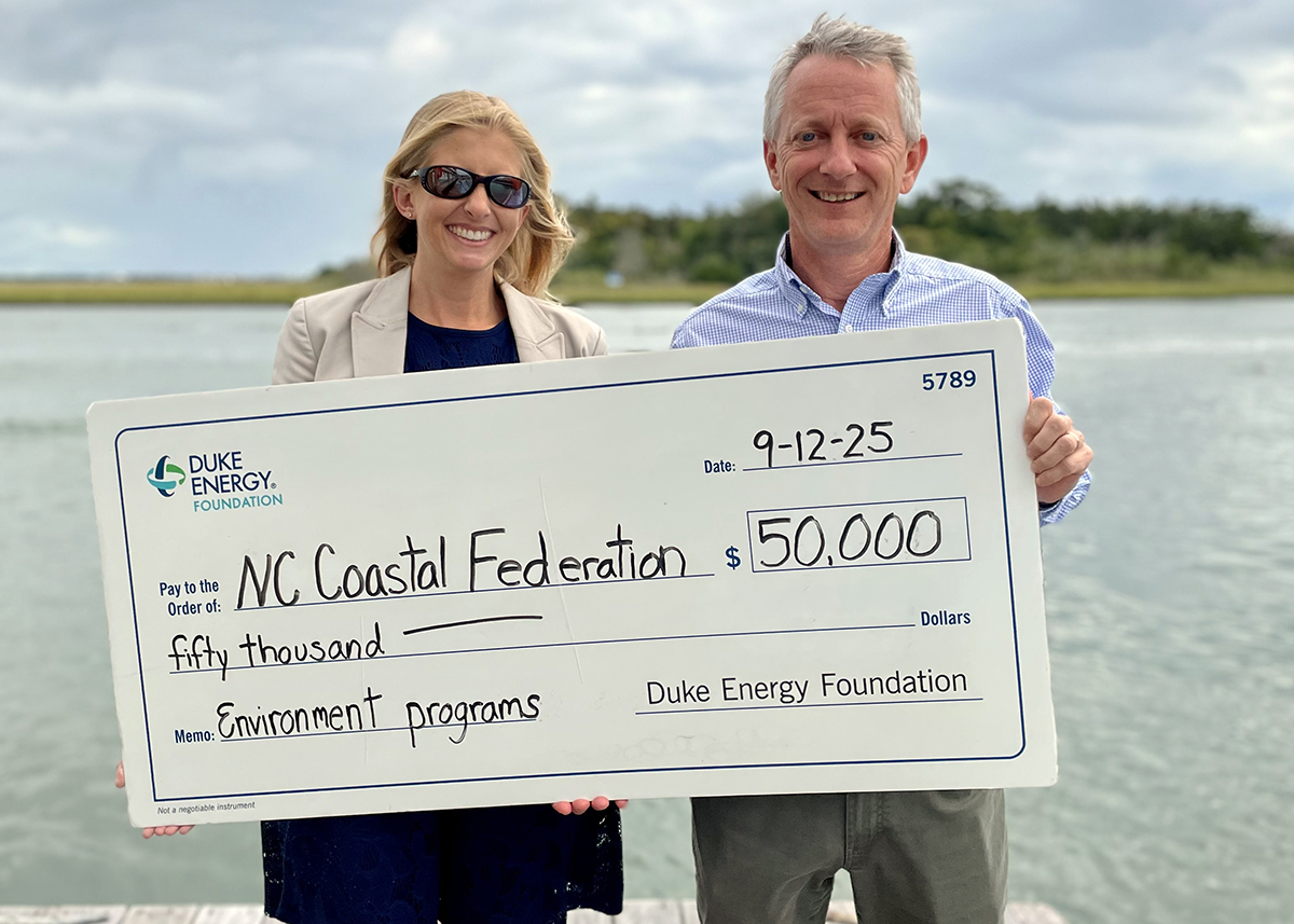 Duke Energy Foundation District Manager, Government and Community Relations, Lauren Wargo presents a ceremonial $50,000 check to North Carolina Coastal Federation Executive Director Braxton Davis earlier this month in Morehead City.