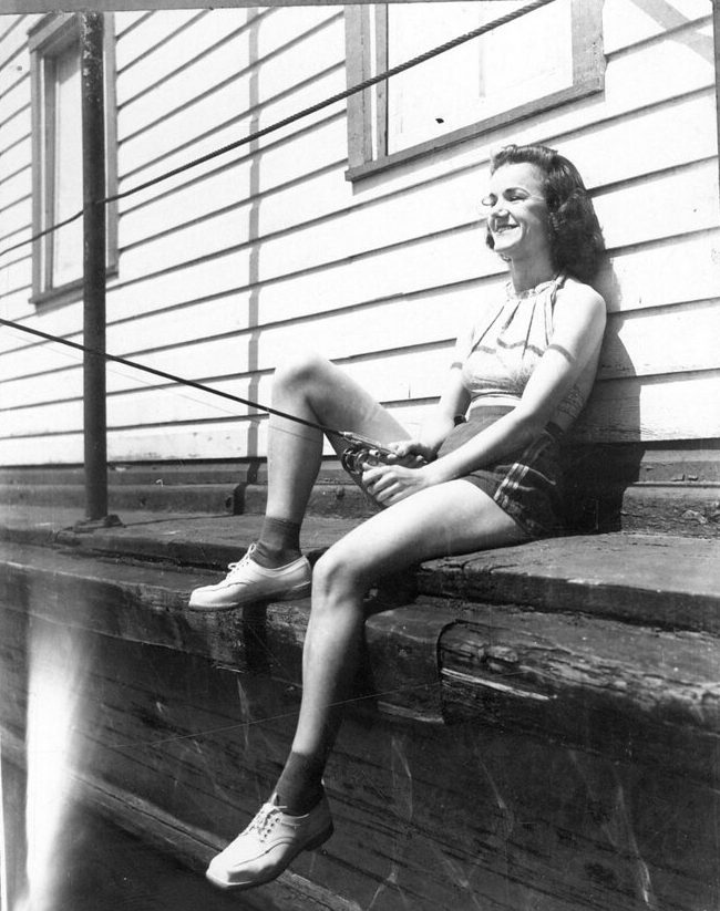 One of the theater troupe’s actresses fishing in the Pamlico River while the James Adams Floating Theatre was docked in Washington, N.C., 1940. Photo courtesy, State Archives of North Carolina