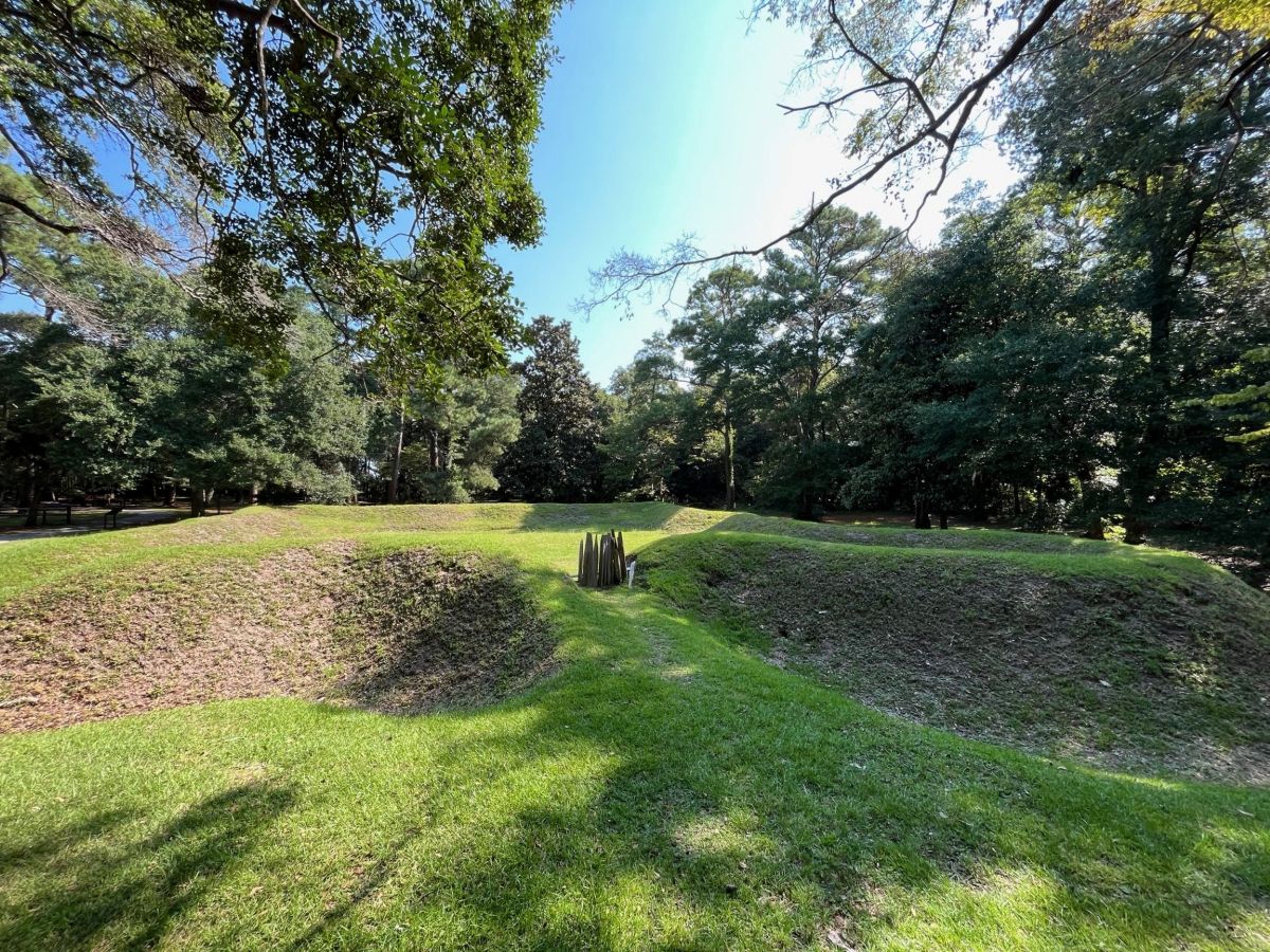 A photo of the reconstructed Earthen Fort with trees behind it at Fort Raleigh National Historic Site.