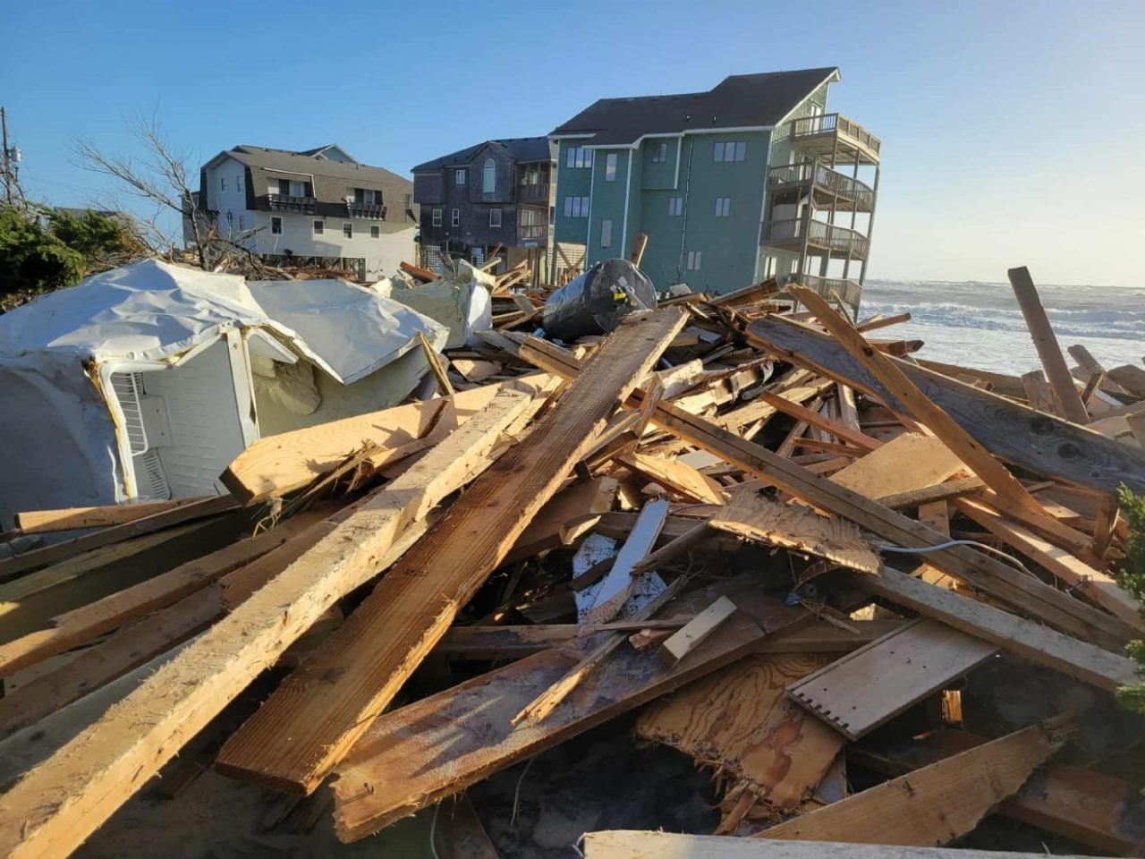 Debris from homes that collapsed this week line the Buxton oceanfront on Hatteras Island early Thursday. Photo: Joy Crist/Island Free Press