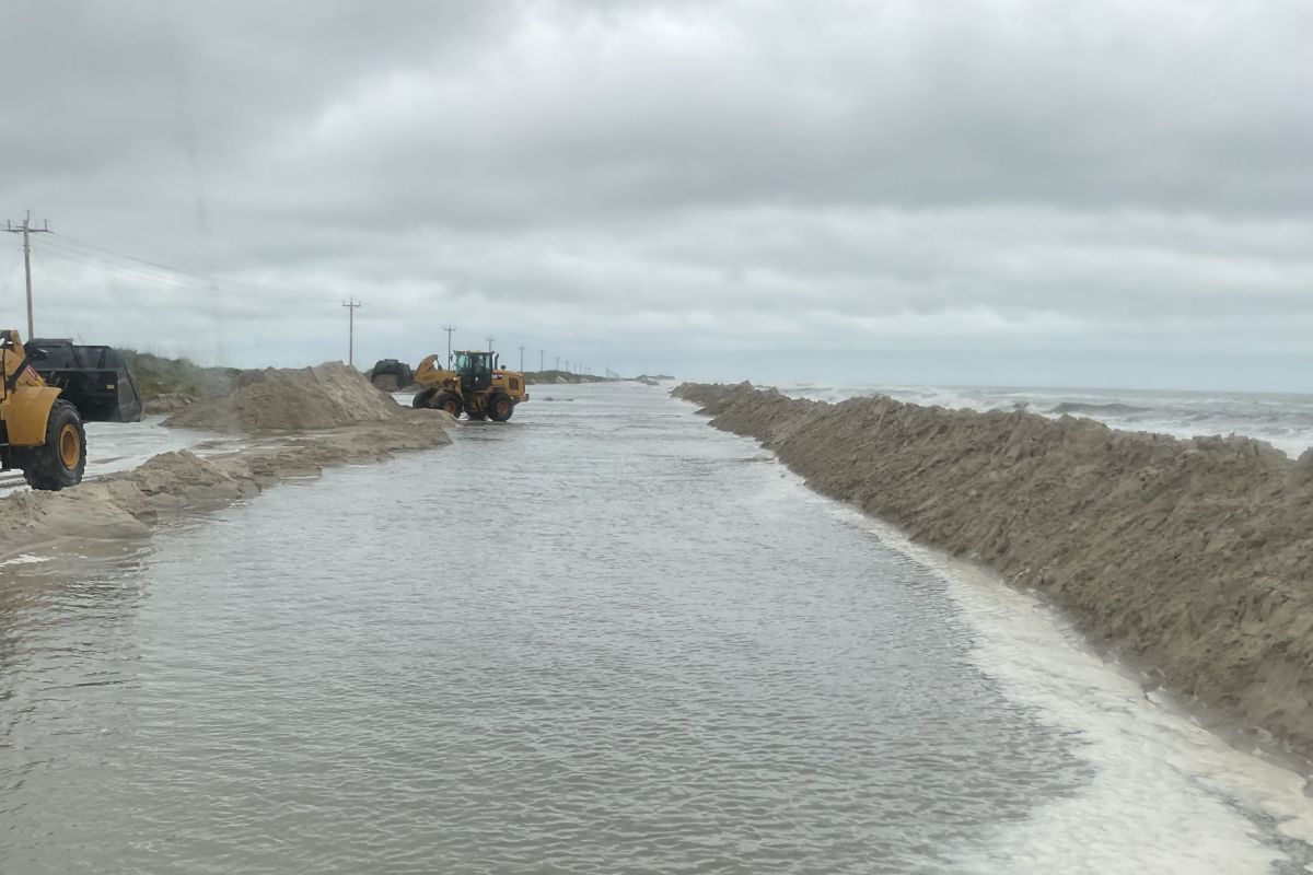 North Carolina Department of Transportation crews work to rebuild the dune next to N.C. 12 earlier this week on the north end of Ocracoke Island. Photo: NCDOT