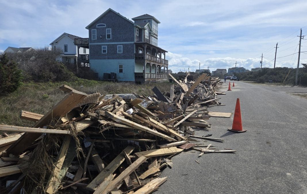 Debris lines the street Sunday following the collapse of nine oceanfront homes last week in Buxton and Rodanthe. Photo: Don Bowers