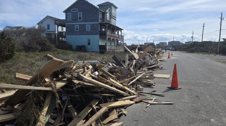 Debris lines the street Sunday following the collapse of nine oceanfront homes last week in Buxton and Rodanthe. Photo: Don Bowers