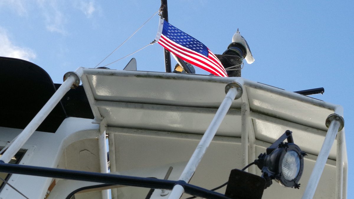 A gull keeps a patriotic watch on the North Carolina Department of Transportation Ferry Division's vehicle ferry Kinnakeet as it plies the Neuse River between Minnesott Beach and Cherry Branch. Photo: Mark Hibbs