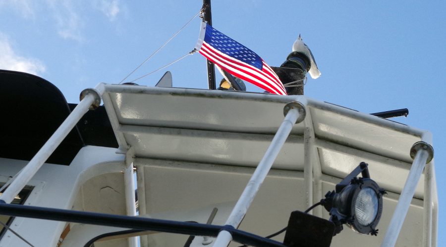 A gull keeps a patriotic watch on the North Carolina Department of Transportation Ferry Division's vehicle ferry Kinnakeet as it plies the Neuse River between Minnesott Beach and Cherry Branch. Photo: Mark Hibbs