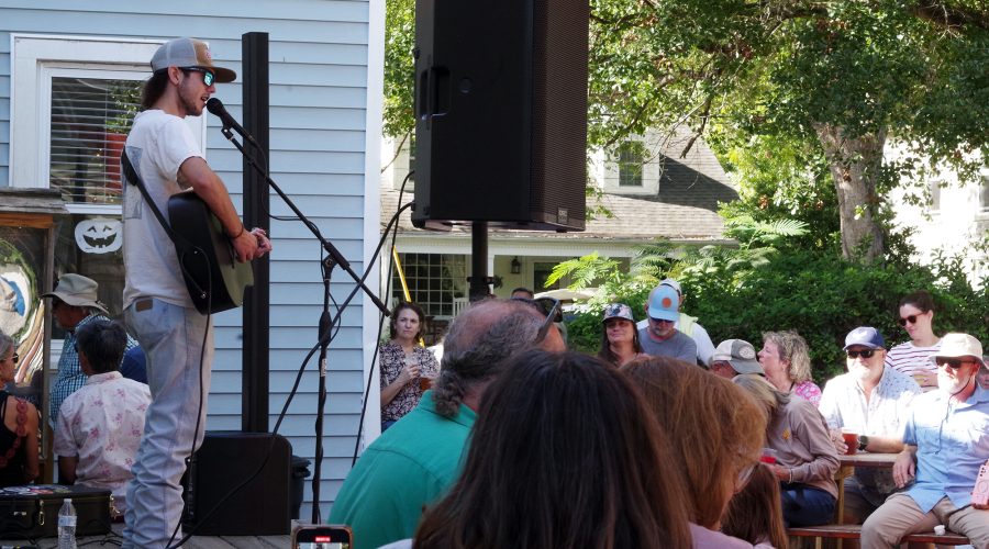 Fingerstyle guitarist and vocalist Noah Cobb, 18, of Greenville, performs Saturday at the New Village Brewery in Oriental as part of the Pamlico County village's two-day Ol' Front Porch Music Festival, which was free to attend and brought together folk, Americana, bluegrass, country, gospel, blues and jazz performers on numerous stages sited within walking distance of one another. Photo: Mark Hibbs