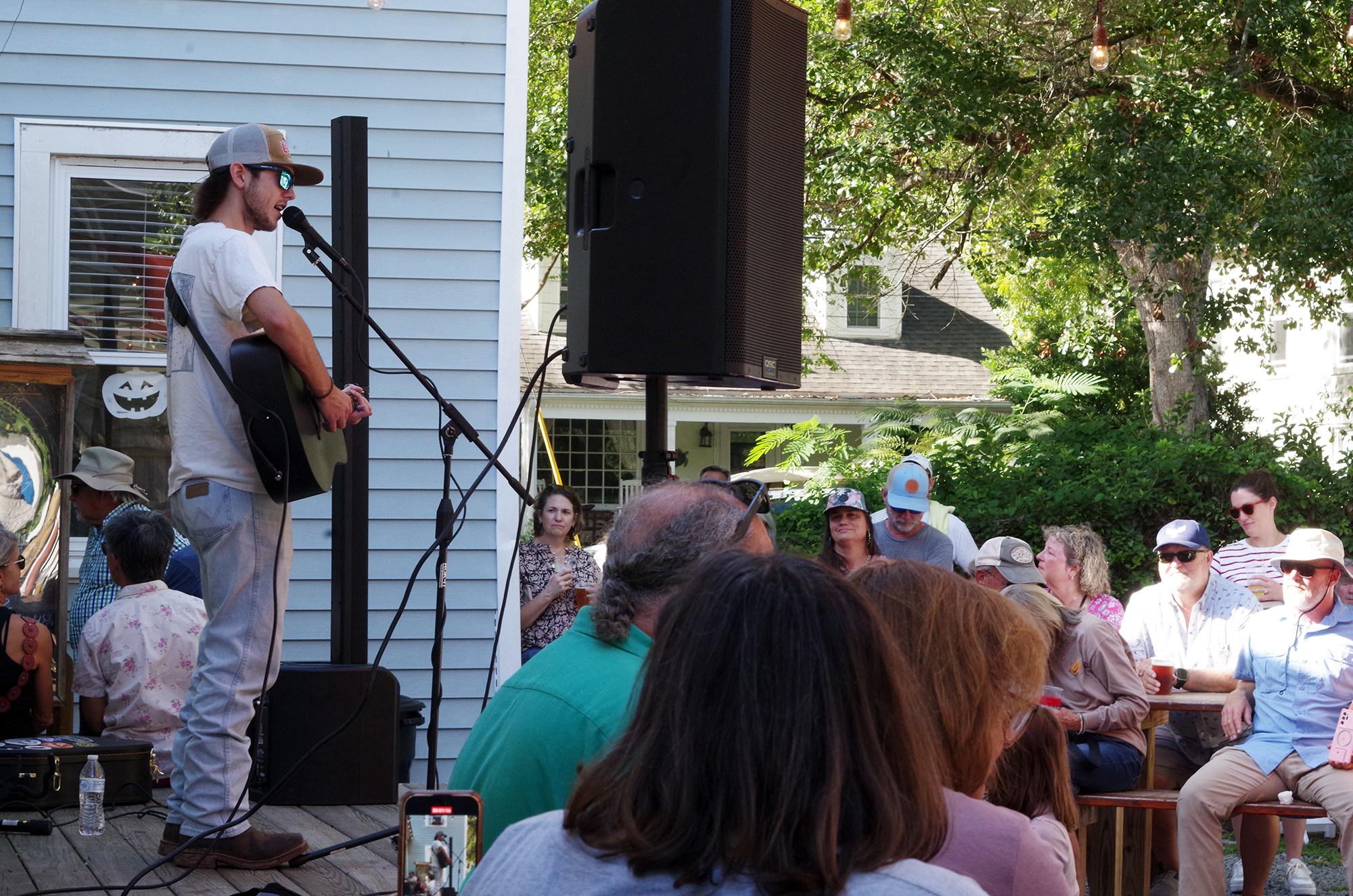 Fingerstyle guitarist and vocalist Noah Cobb, 18, of Greenville, performs Saturday at the New Village Brewery in Oriental as part of the Pamlico County village's two-day Ol' Front Porch Music Festival, which was free to attend and brought together folk, Americana, bluegrass, country, gospel, blues and jazz performers on numerous stages sited within walking distance of one another. Photo: Mark Hibbs