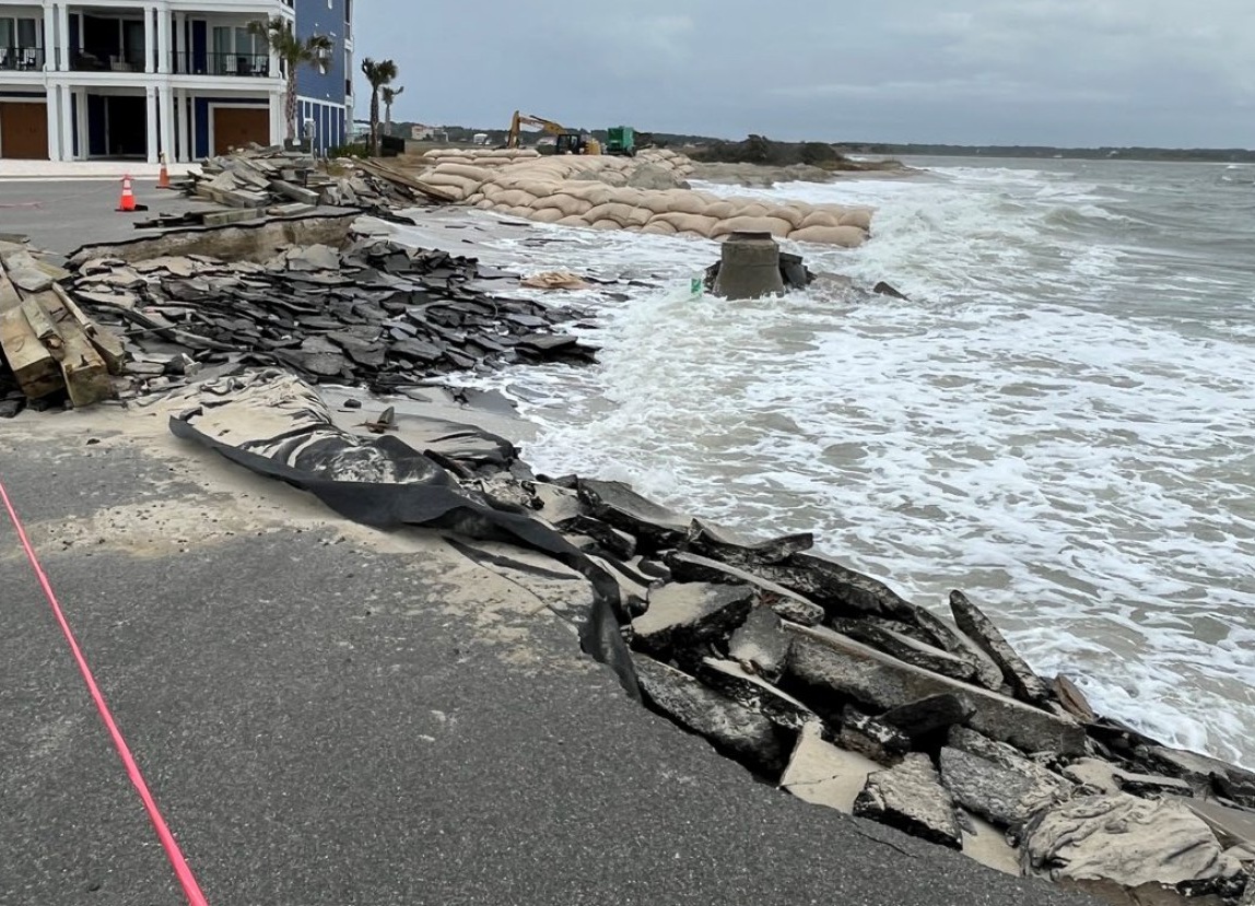 Wave energy eats away at the roadway in The Pointe gated neighborhood on Ocean Isle Beach. Photo: NCDEQ
