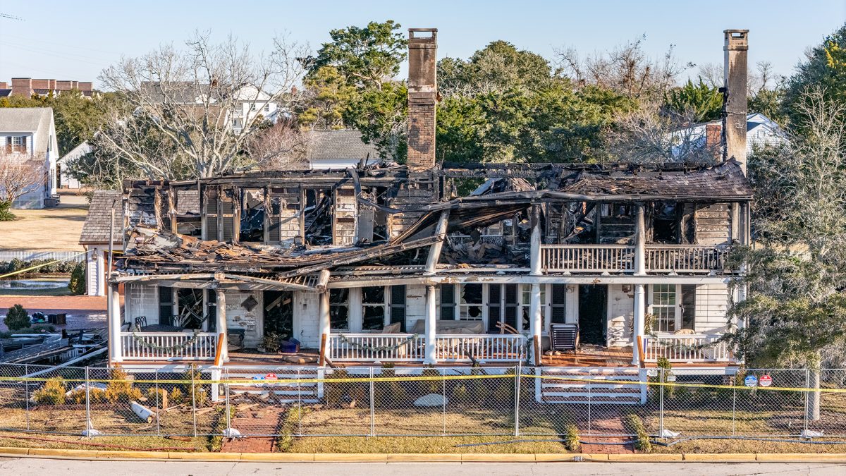 The Duncan House at 105 Front St. in Beaufort, a structure that dates back to the mid-1700s, is listed on the National Register of Historic Places and is one of only 11 properties in North Carolina designated as Statewide Properties of Significance, is cordoned off Tuesday after a blaze consumed the unoccupied building on Monday. Photo: Dylan Ray