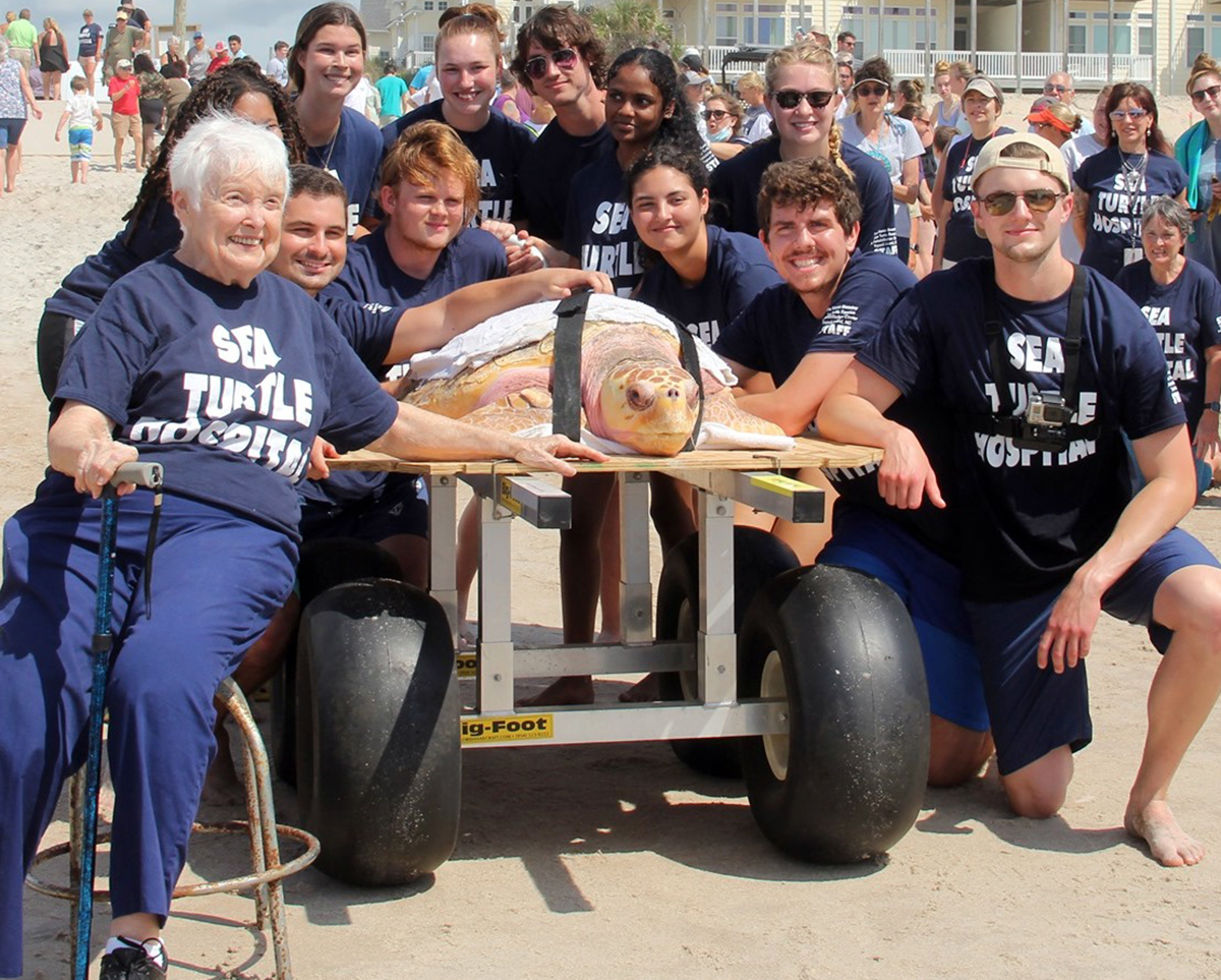 Jean Beasley, far left, poses with a sea turtle patient and center staff in this photo from the Karen Beasley Sea Turtle Rescue and Rehabilitation Center's Facebook page.