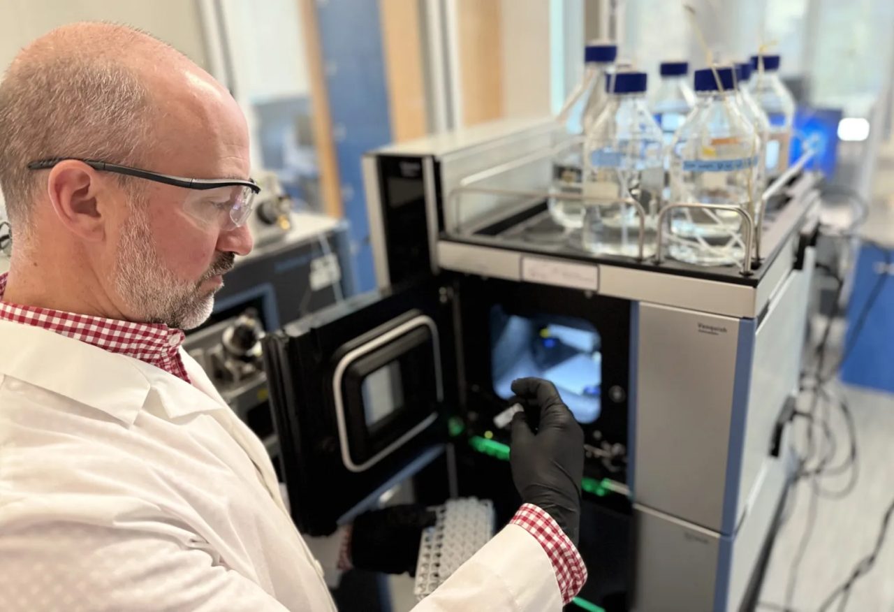 Lee Ferguson loads a water sample into one of his laboratory’s powerful mass spectrometers, which are used to discover chemicals and contaminants in environmental samples. Photo: Duke University