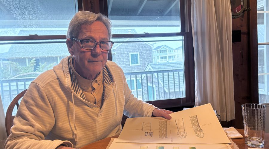 George Jackson, at his family’s Kill Devil Hills cottage, shows the original sketches used for the book. Photo: Catherine Kozak