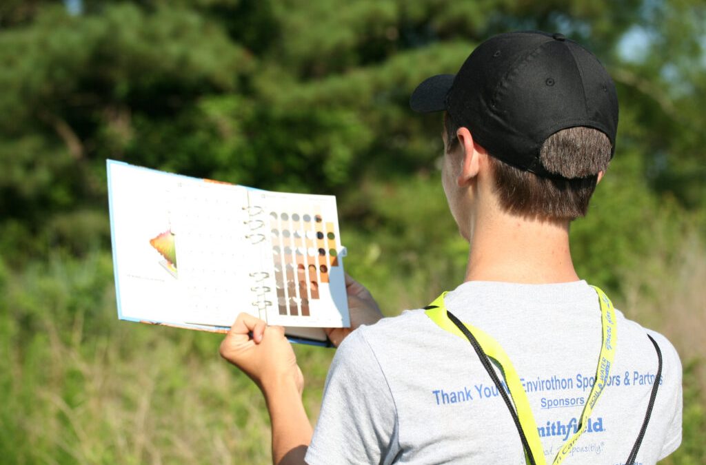 A past Resource Conservation Workshop youth explores soil color. Photo: N.C. State