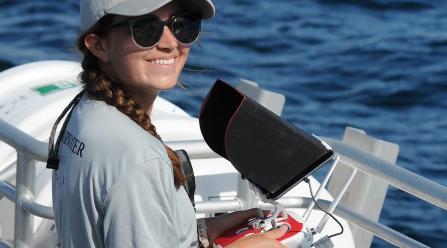 Anne Harshbarger operates a drone during a whale survey off Cape Hatteras. Photo: Courtesy of Anne Harshbarger