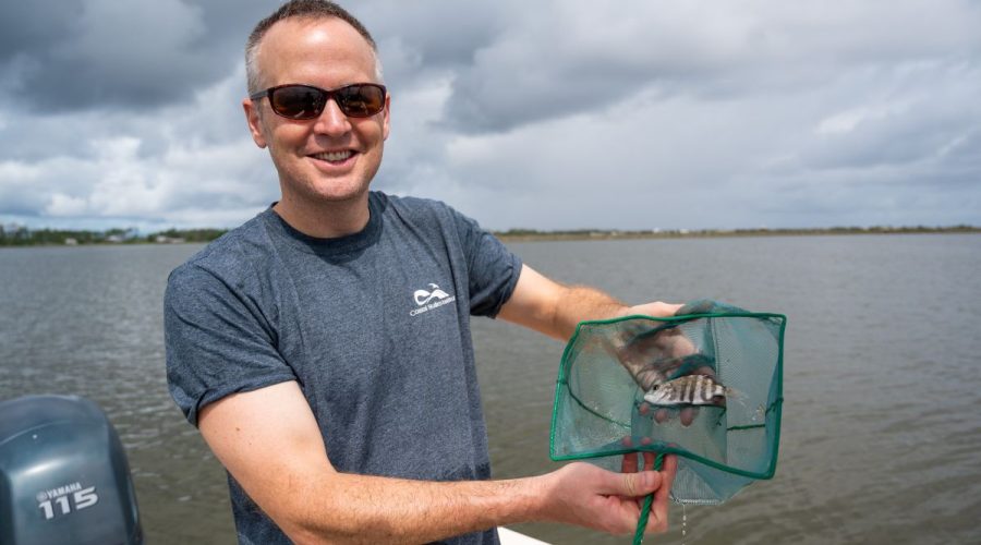 Dr. Jim Morley, assistant professor in the Department of Biology at East Carolina University, poses with a sheepshead. Photo: ECU