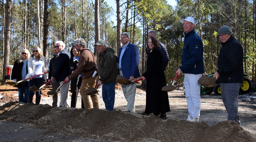 State Rep. Celeste Cairns, fifth from left, joins Carteret County commissioners and staff in a ceremonial groundbreaking Friday for a new boat launch facility in the western part of the county. Photo: Mark Hibbs
