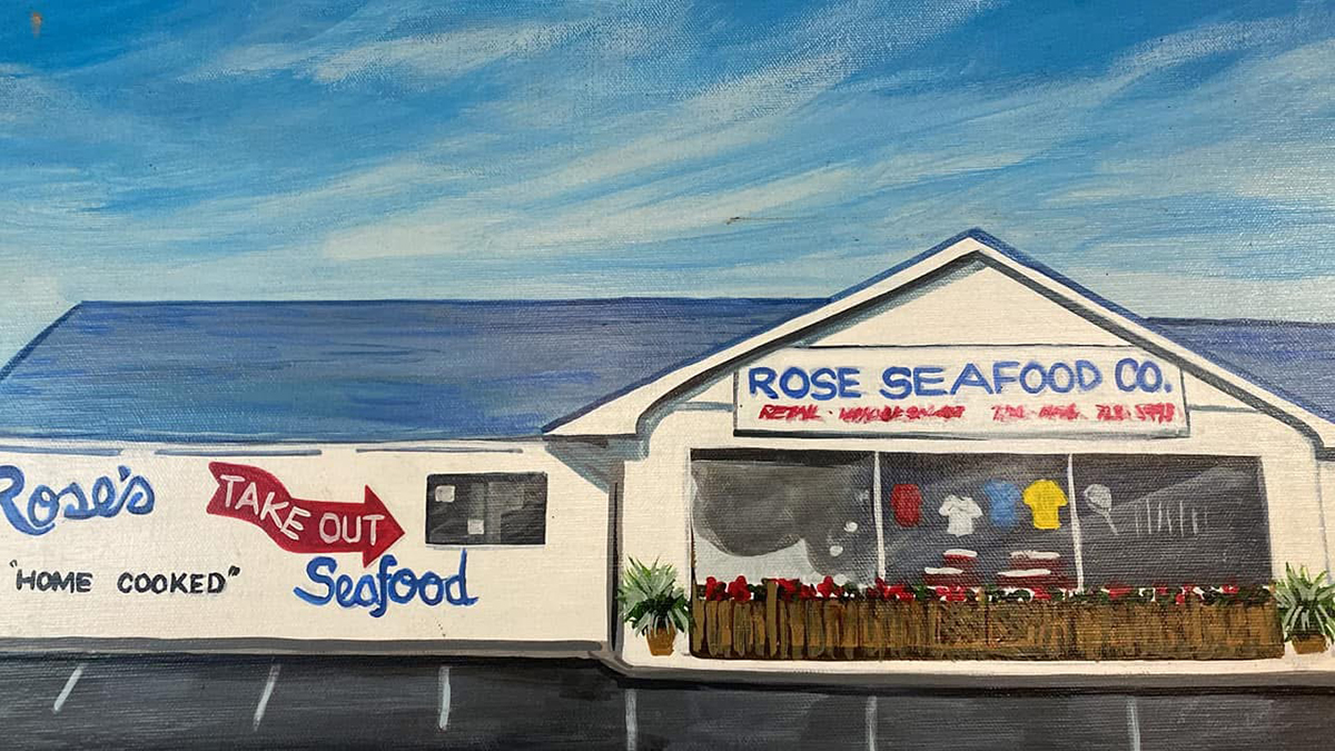 The red, white and blue facade at the early Rose Seafood in Beaufort is depicted in this painting.