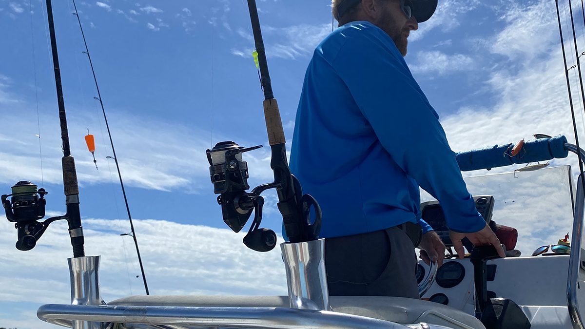 Capt Rick shows off the smart angler's summer uniform, including long sleeves and a long-billed cap. Photo: Gordon Churchill