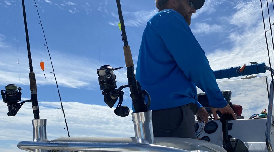 Capt Rick shows off the smart angler's summer uniform, including long sleeves and a long-billed cap. Photo: Gordon Churchill