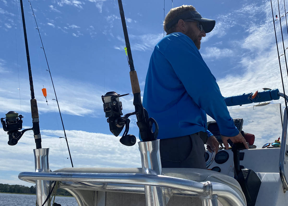 Capt Rick shows off the smart angler's summer uniform, including long sleeves and a long-billed cap. Photo: Gordon Churchill
