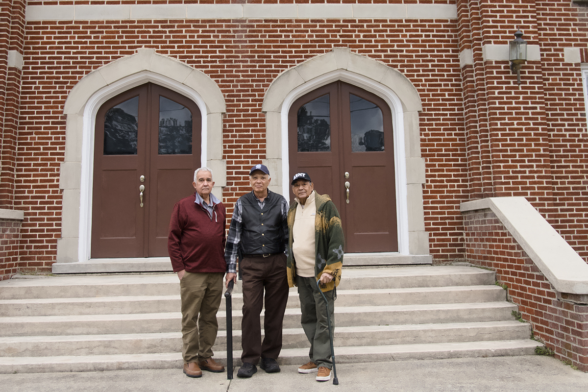 Members of the Pleasant Plains Baptist Church who have taken the lead in restoring the Pleasant Plains School, from left, Roy Pierce, Deacon Dr. Terry Hall, Chief Thomas Lewis of the Meherrin Nation, pose in mid-February in front of the Pleasant Plains Baptist Church. Photo: Kip Tabb